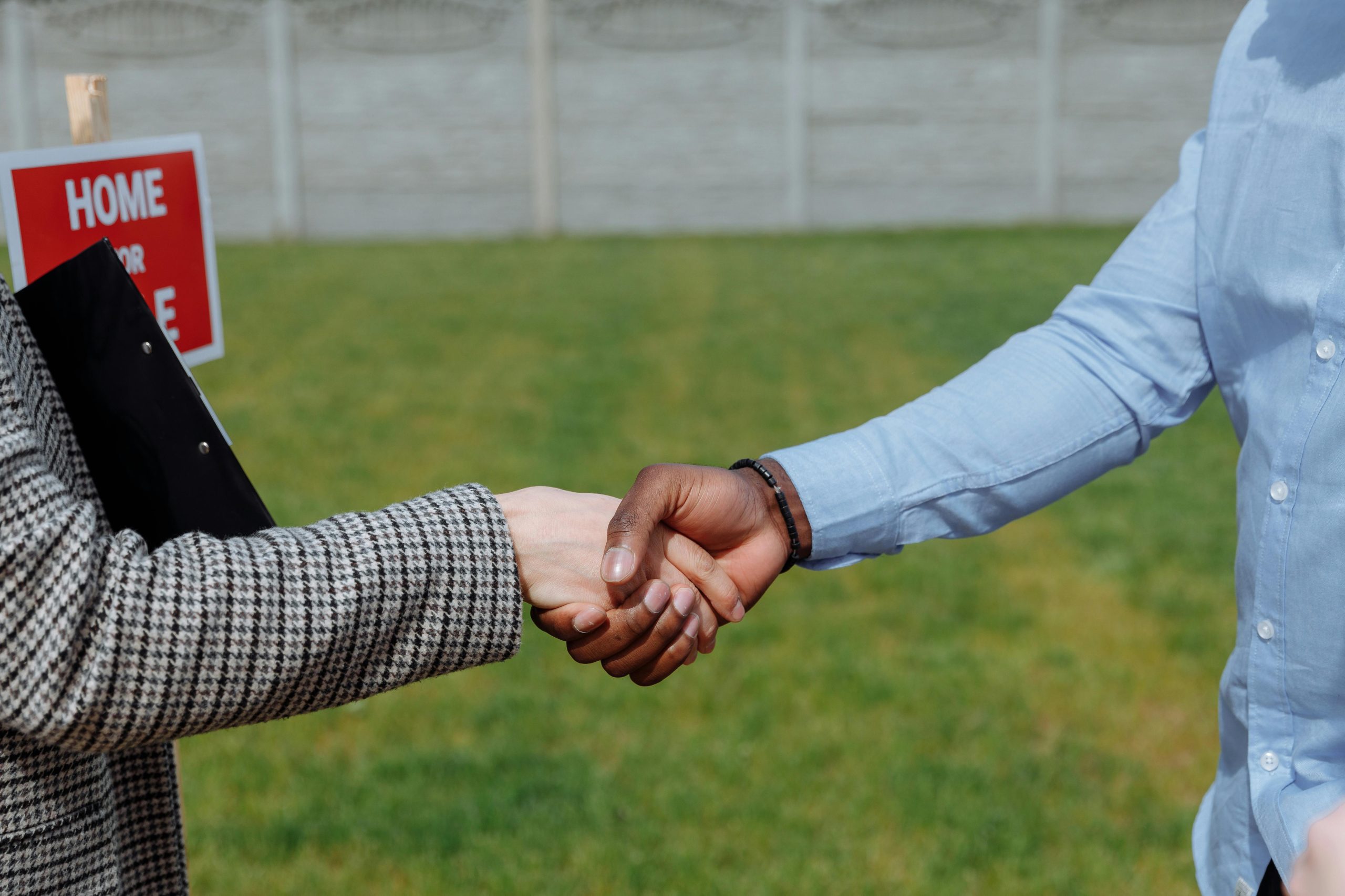 Two business professionals shaking hands after successfully closing a deal, symbolizing partnership and collaboration