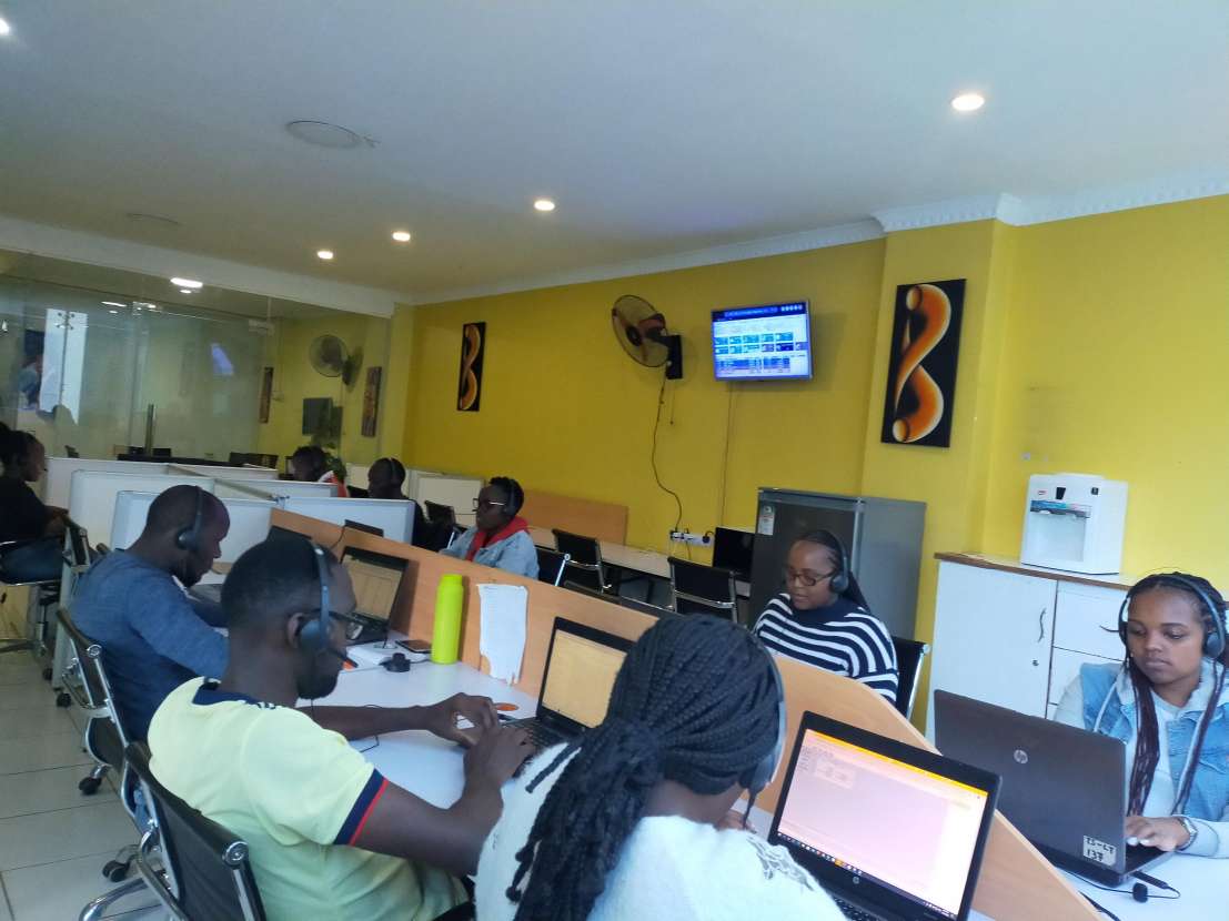 Customer care agents at [Your BPO Name] working diligently in the office. The image shows a vibrant team engaged in providing excellent support, with agents answering calls, handling inquiries, and collaborating to solve problems. The workspace is filled with energy and focus, reflecting their commitment to delivering top-notch service and ensuring client satisfaction